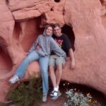 Picture of CoolBiz Web Design's Founder and His Wife Sitting in a Natural Hole in the Face of a Red Rock Cliff in the Valley of Fire State Park in Nevada